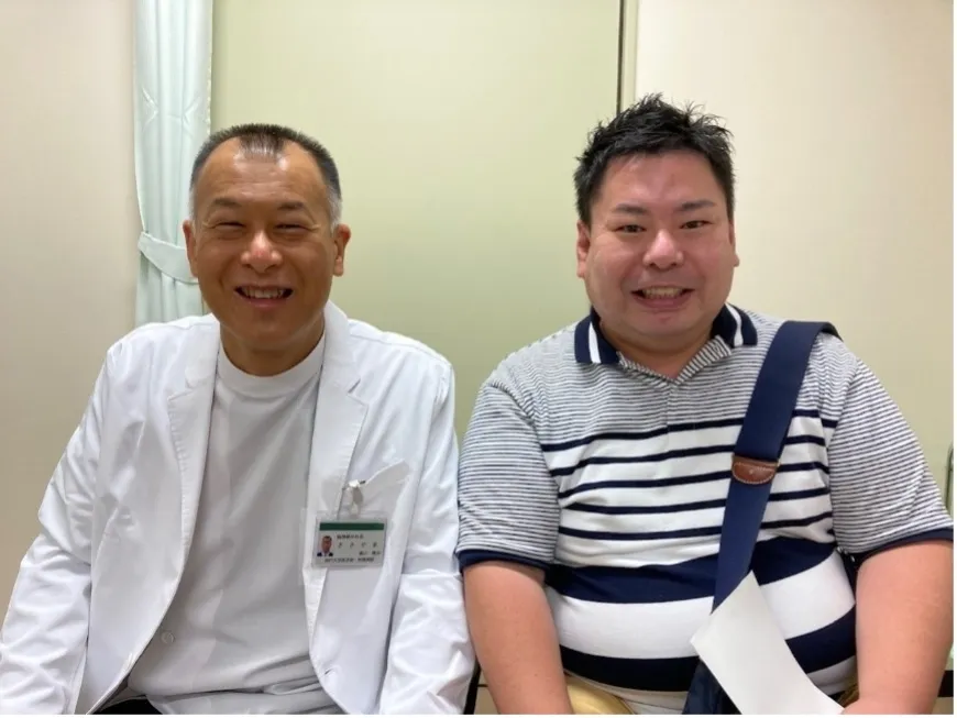 主治医と並んで微笑む津曲祐司さん